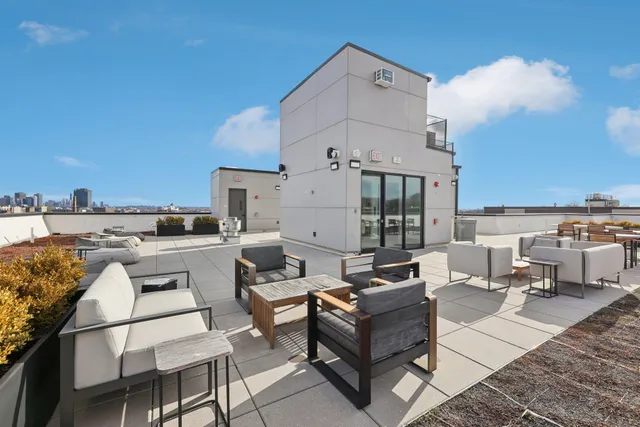 a terrace with outdoor seating and city view