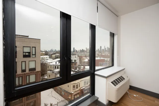 a view of an entryway with wooden floor and door