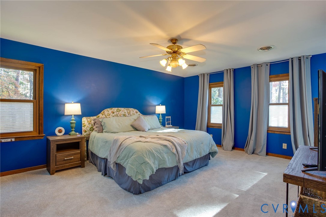 12930 Donegal Drive Chesterfield, VA 23832 - Photo 17 of 43 a spacious bedroom with a bed and a chandelier
