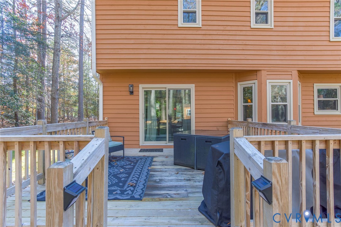 12930 Donegal Drive Chesterfield, VA 23832 - Photo 30 of 43 a front view of a house with wooden stairs and a large tree