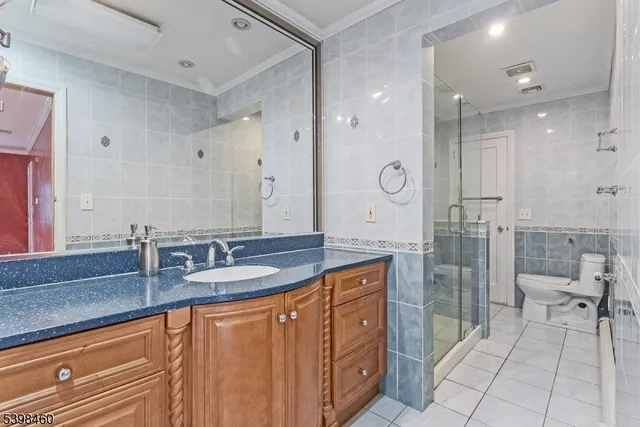 a bathroom with a granite countertop sink a mirror and a shower