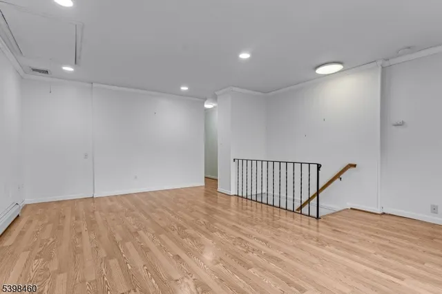 a view of a room with wooden floor