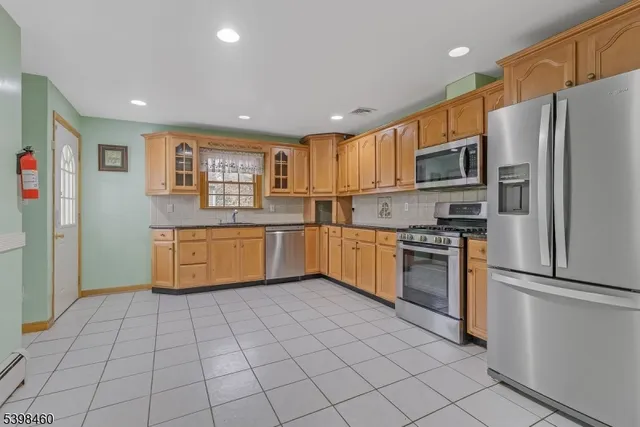 a kitchen with stainless steel appliances granite countertop a refrigerator sink and cabinets