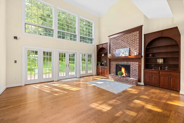 a view of an empty room with a fireplace and a window