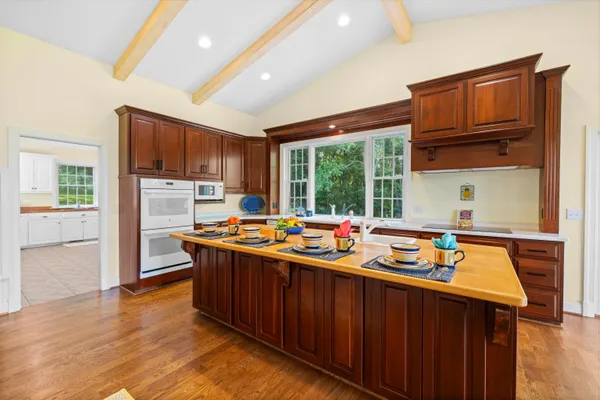 a large kitchen with lots of counter space and wooden floor