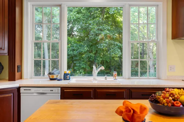 a view of an empty room with a fireplace and a window