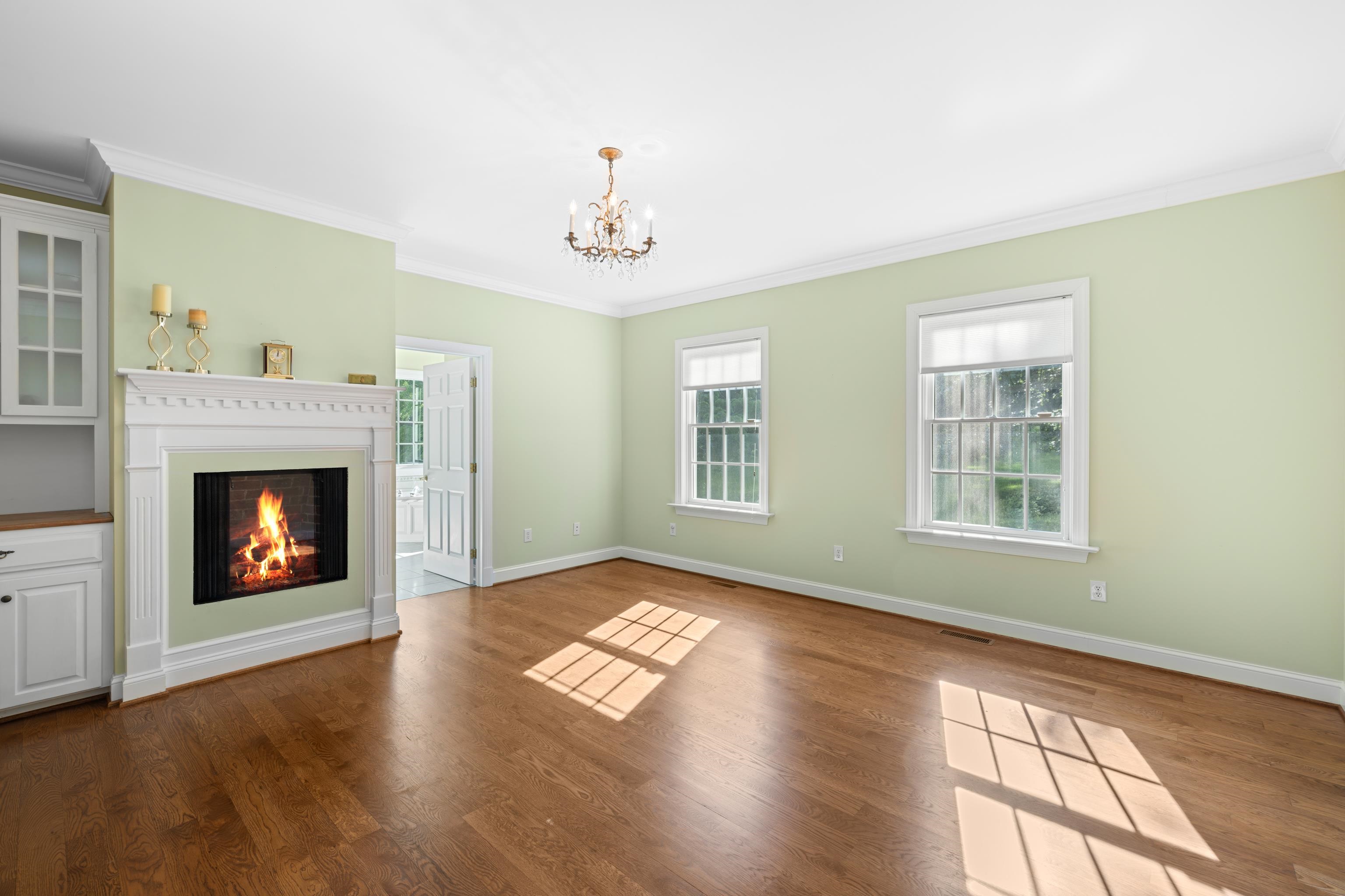 296 Otts Ml Road Raphine, VA 24472 - Photo 27 of 75 a view of an empty room with wooden floor fireplace and a window