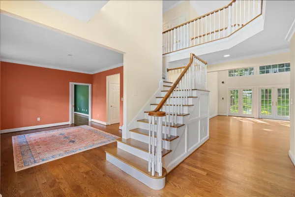 a view of entryway with wooden floor and stairs