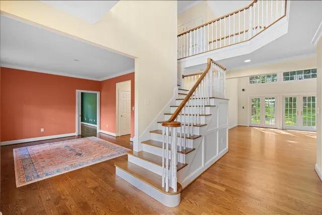 a view of a swimming pool with lawn chairs under an umbrella