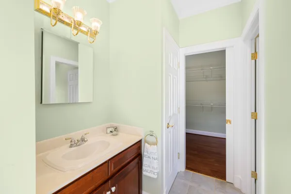 a bathroom with a sink toilet and mirror