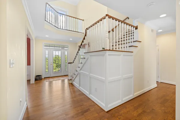 a view of a swimming pool with lawn chairs under an umbrella