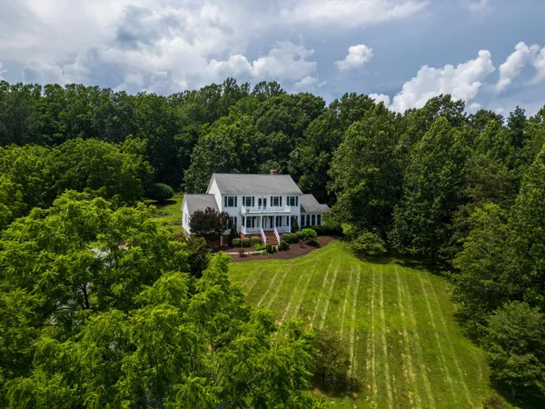 a front view of house with yard and green space