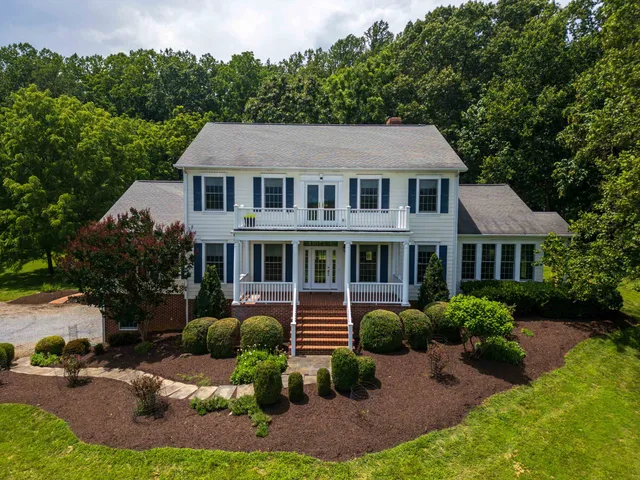 a view of a hallway with wooden floor and a chandelier