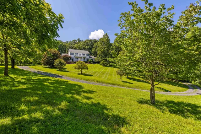 a view of a livingroom with wooden floor and a fireplace