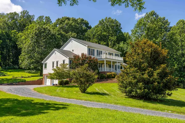 a view of a livingroom with wooden floor and a fireplace