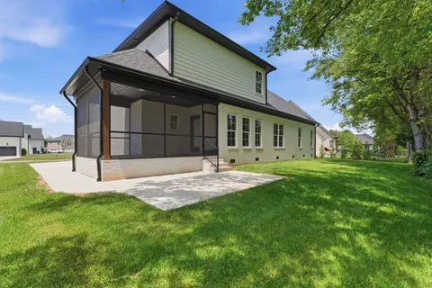 a front view of a house with a yard and porch