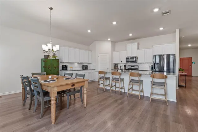 a living room with furniture a chandelier and a rug