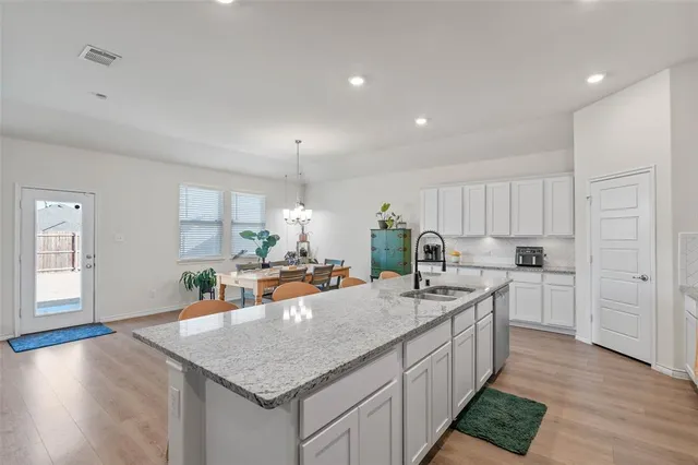 a kitchen with counter top space and wooden floor