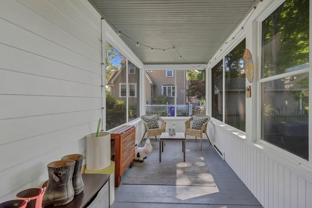29 Waldeck Road Milton, MA 02186 - Photo 12 of 13 a balcony with couple of chairs and a potted plant on a table