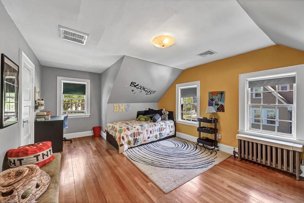 29 Waldeck Road Milton, MA 02186 - Photo 9 of 13 a bedroom with furniture and a wooden floor