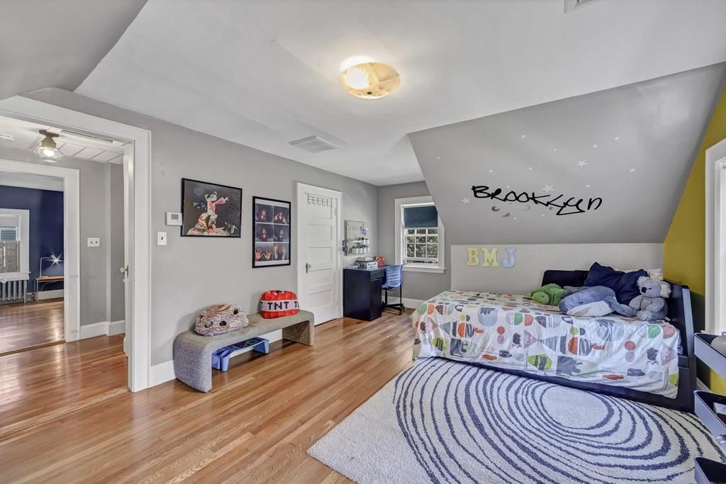 29 Waldeck Road Milton, MA 02186 - Photo 10 of 13 a bedroom with a bed and wooden floor