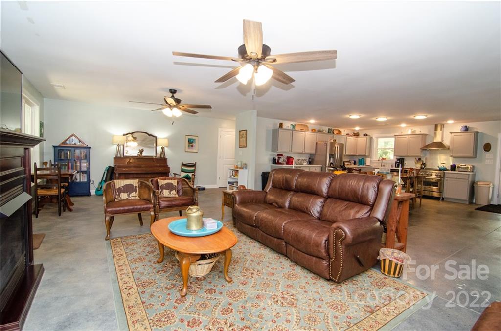 3267 Park Road Ridgeway, SC 29130 - Photo 11 of 40 a living room with furniture a dining table and a fireplace