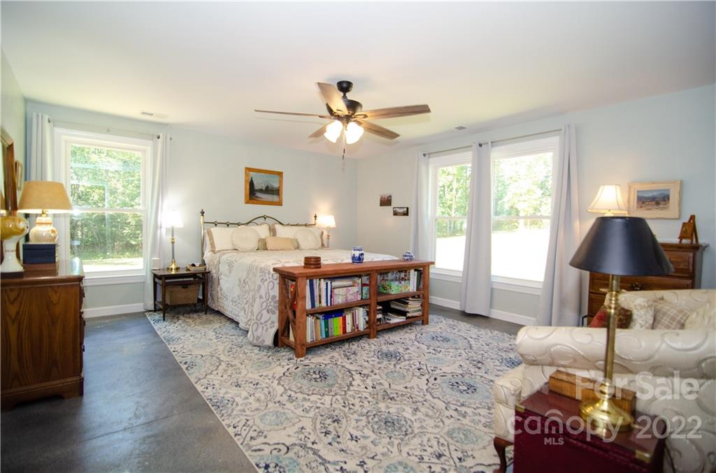3267 Park Road Ridgeway, SC 29130 - Photo 14 of 40 a bedroom with a bed and a chandelier