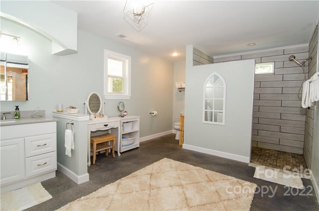 3267 Park Road Ridgeway, SC 29130 - Photo 16 of 40 a spacious bathroom with a double vanity sink a mirror and a shower