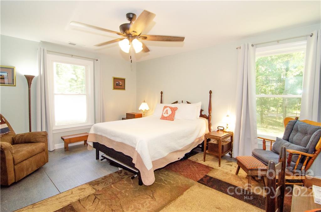 3267 Park Road Ridgeway, SC 29130 - Photo 19 of 40 a bedroom with a bed a couch and a chandelier
