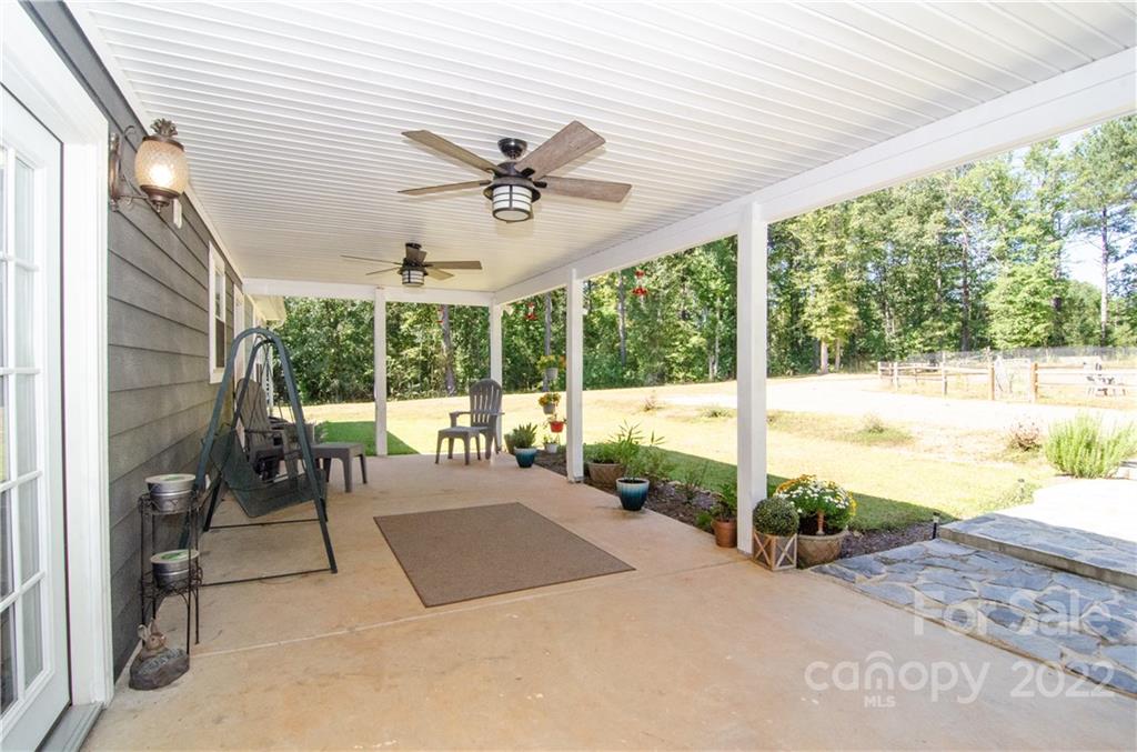 3267 Park Road Ridgeway, SC 29130 - Photo 3 of 40 a view of a patio with a table chairs and a floor to ceiling window