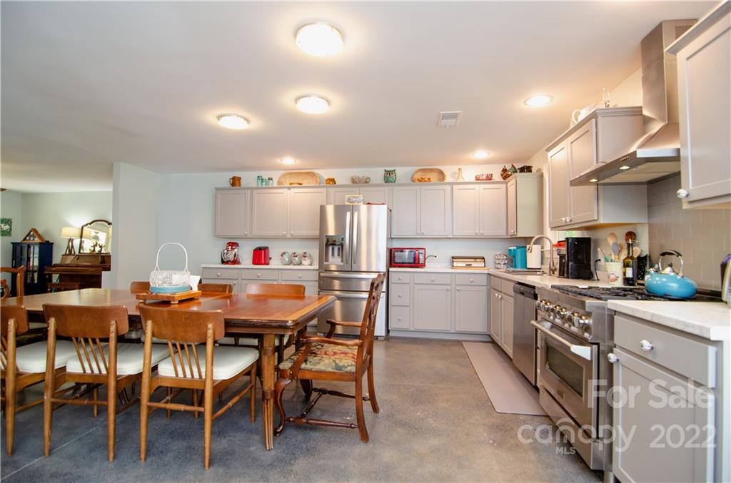3267 Park Road Ridgeway, SC 29130 - Photo 6 of 40 a kitchen with a table chairs and a refrigerator