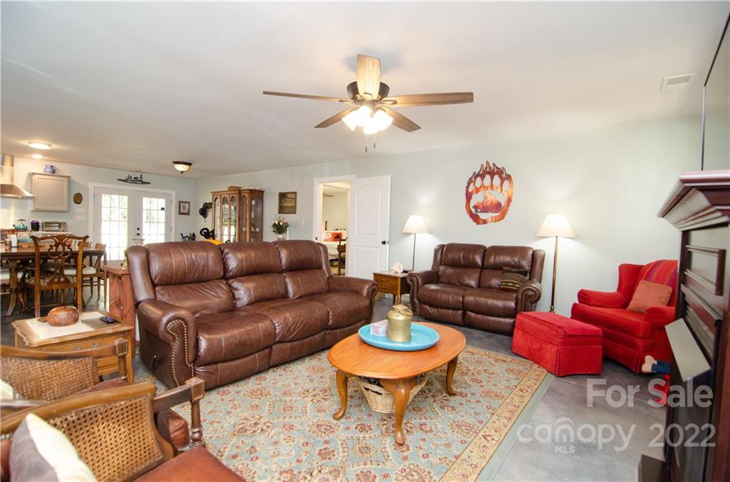 3267 Park Road Ridgeway, SC 29130 - Photo 10 of 40 a living room with furniture a rug and a chandelier