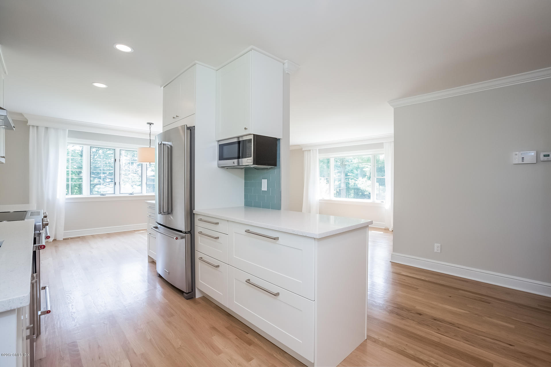 395 Taconic Road Greenwich, CT 06831 - Photo 12 of 36 a kitchen with white cabinets and wooden floor