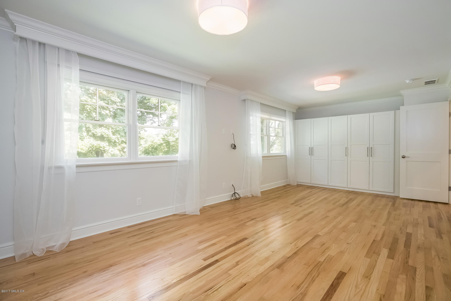 395 Taconic Road Greenwich, CT 06831 - Photo 16 of 36 a view of empty room with wooden floor and fan