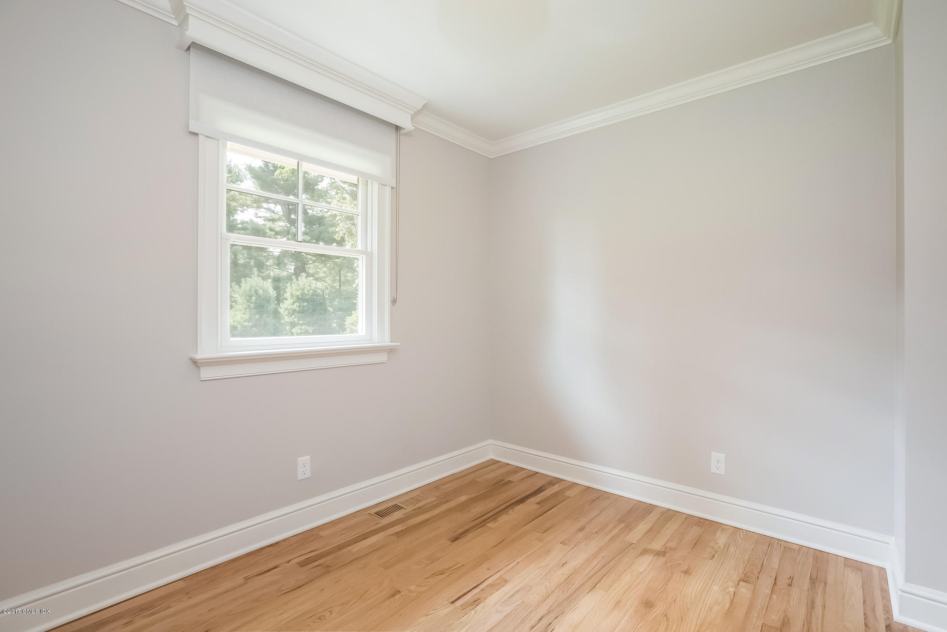 395 Taconic Road Greenwich, CT 06831 - Photo 19 of 36 an empty room with wooden floor and windows
