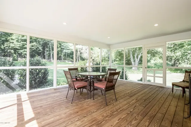 a dining room with furniture and wooden floor