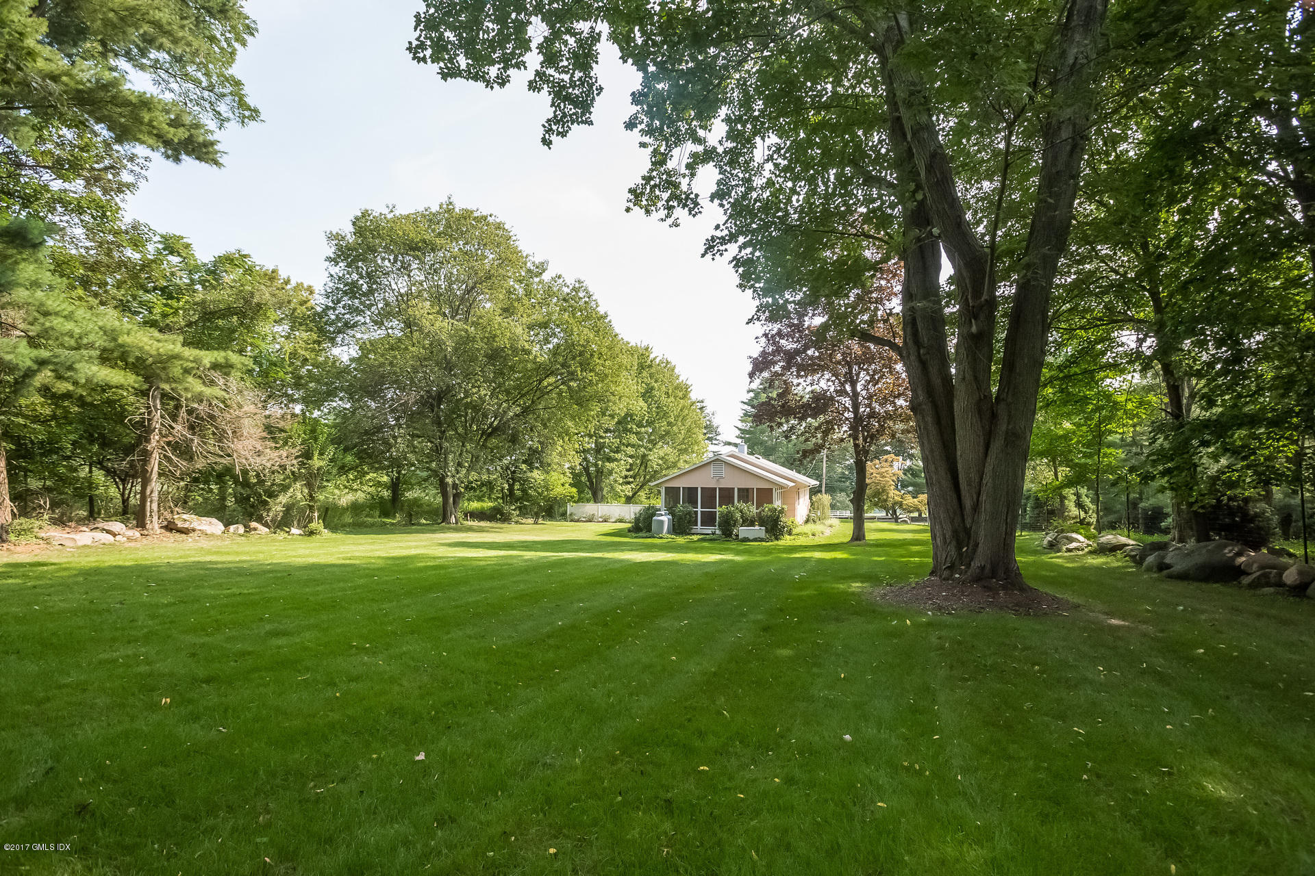 395 Taconic Road Greenwich, CT 06831 - Photo 30 of 36 a view of green field with trees in the background
