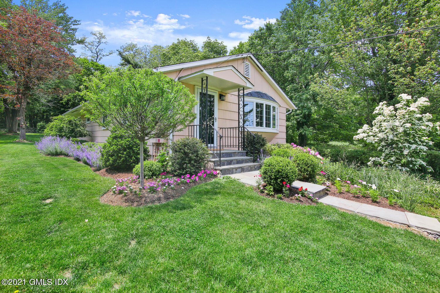 395 Taconic Road Greenwich, CT 06831 - Photo 3 of 36 a front view of a house with a yard