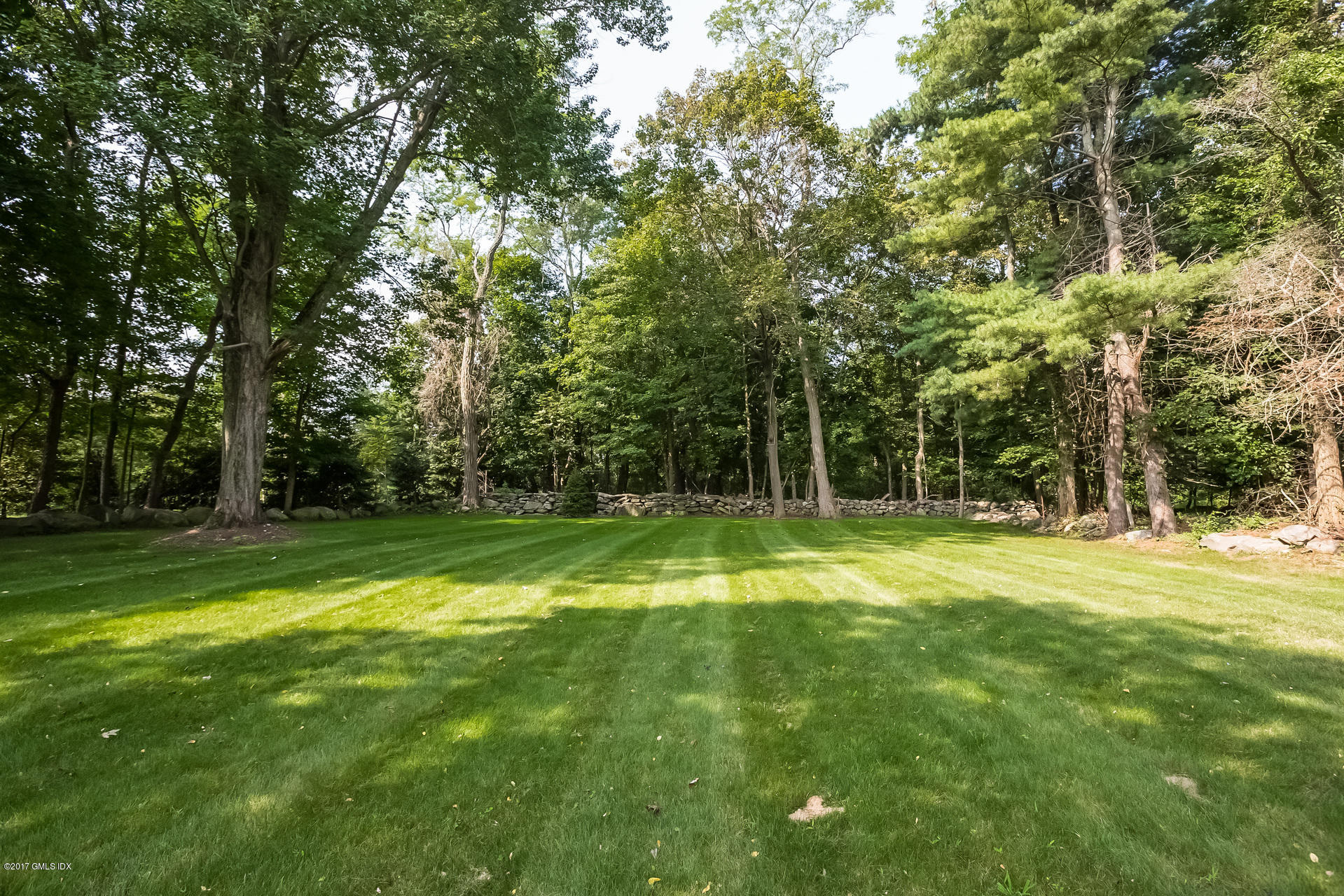 395 Taconic Road Greenwich, CT 06831 - Photo 31 of 36 a swimming pool with wooden fence