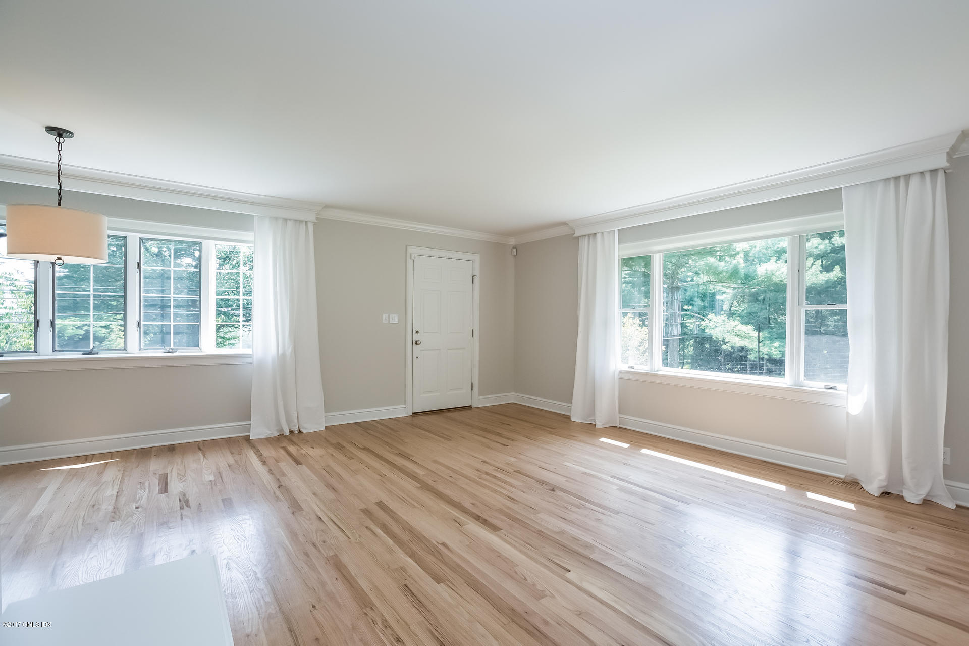 395 Taconic Road Greenwich, CT 06831 - Photo 7 of 36 a view of an empty room with wooden floor and a window