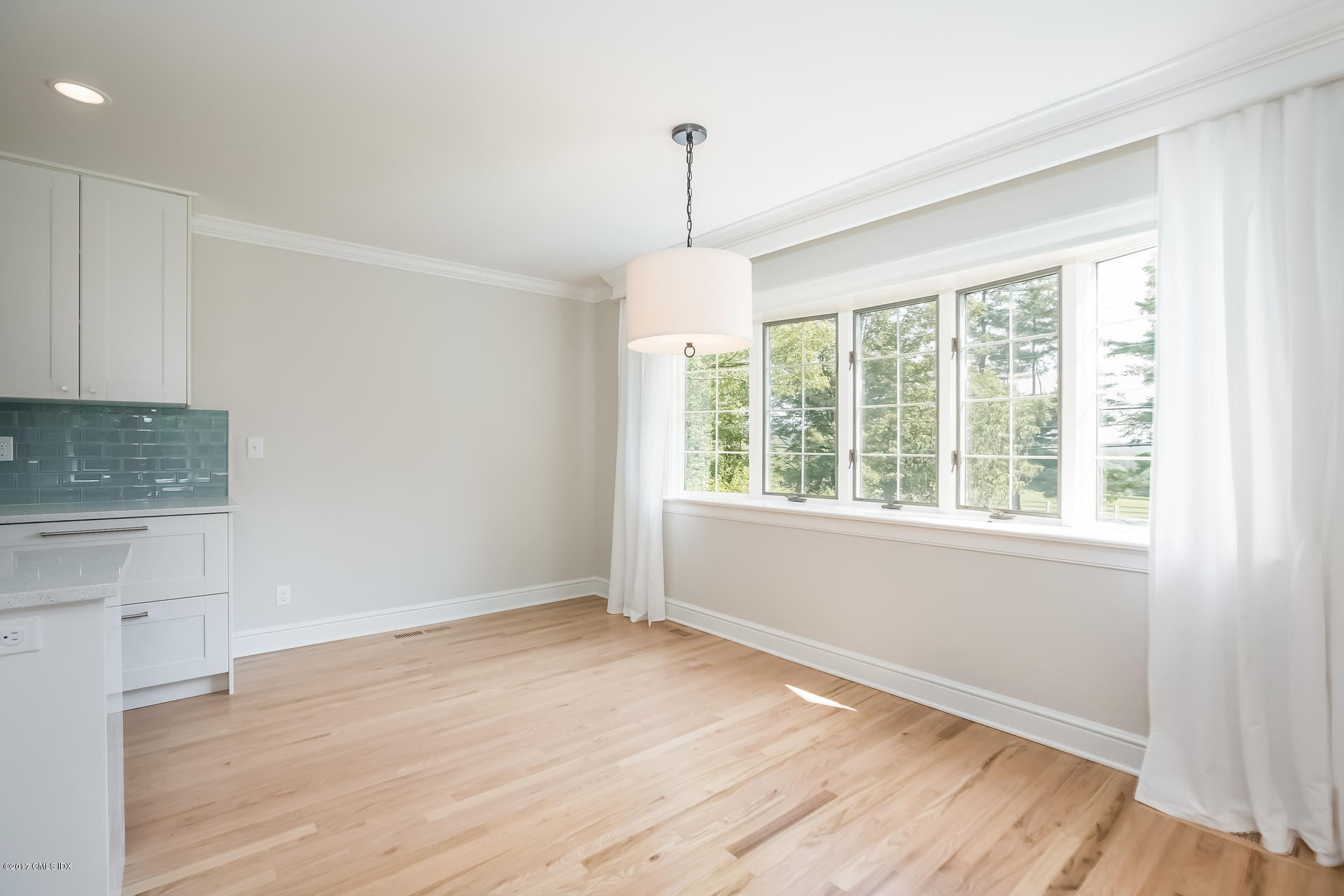 395 Taconic Road Greenwich, CT 06831 - Photo 9 of 36 a view of an empty room with wooden floor and a window