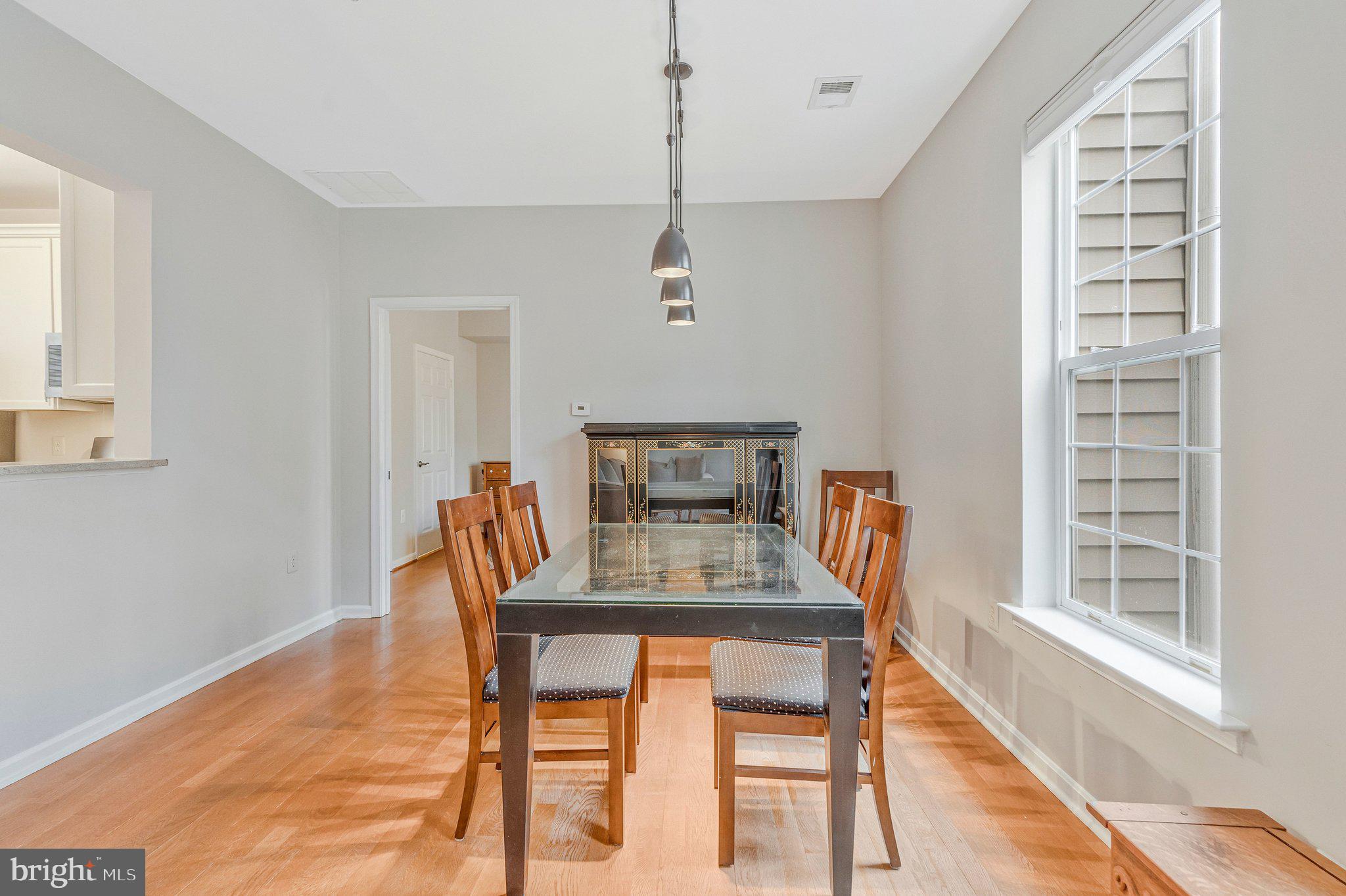 11405 Windleaf Court, Unit 23 Reston, VA 20194 - Photo 12 of 24 a view of a dining room with furniture window and wooden floor