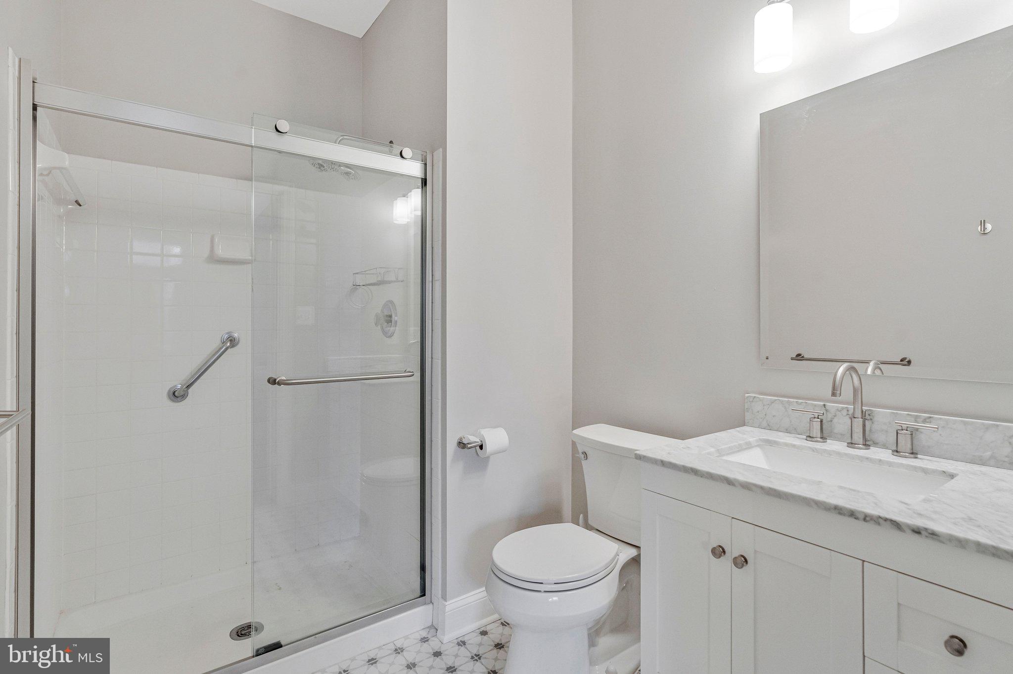 11405 Windleaf Court, Unit 23 Reston, VA 20194 - Photo 18 of 24 a bathroom with a granite countertop sink toilet and shower