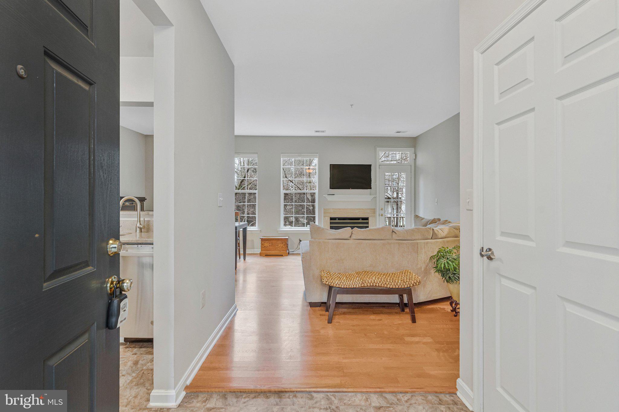 11405 Windleaf Court, Unit 23 Reston, VA 20194 - Photo 3 of 24 a living room with furniture and a wooden floor