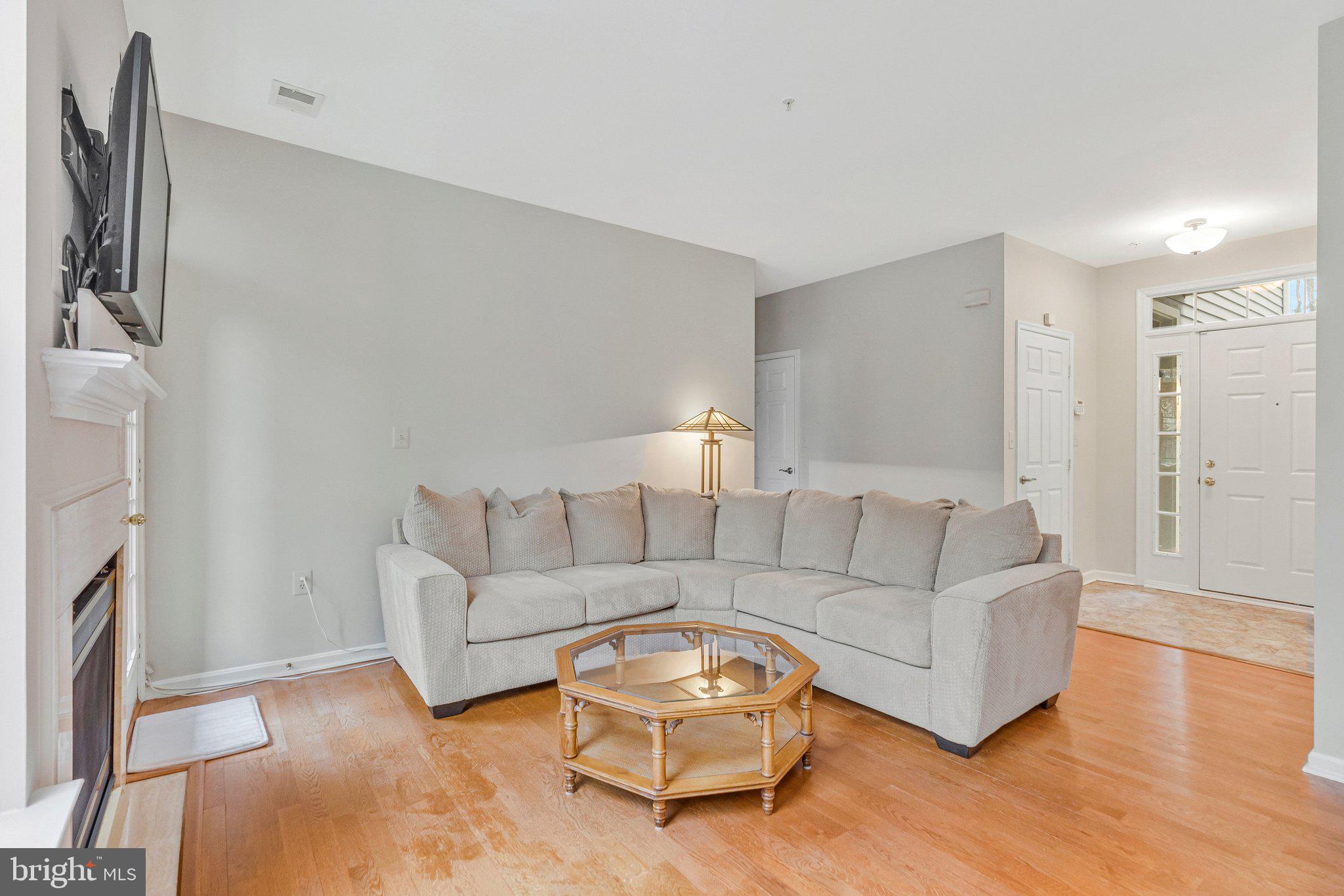 11405 Windleaf Court, Unit 23 Reston, VA 20194 - Photo 10 of 24 a living room with furniture and a fireplace