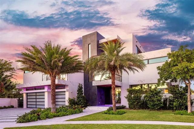 a front view of multiple houses with yard