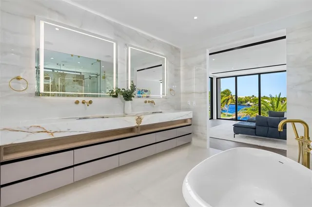 an aerial view of a house with a garden and lake view