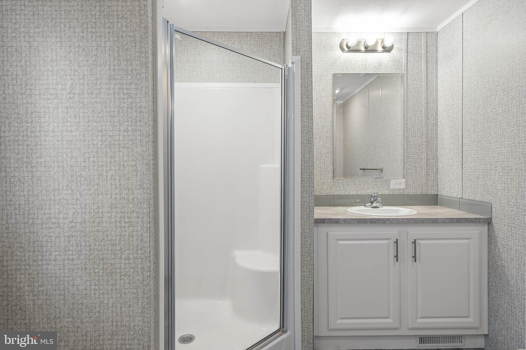17247 Pine Water Drive Lewes, DE 19958 - Photo 15 of 32 a bathroom with a granite countertop sink and a mirror