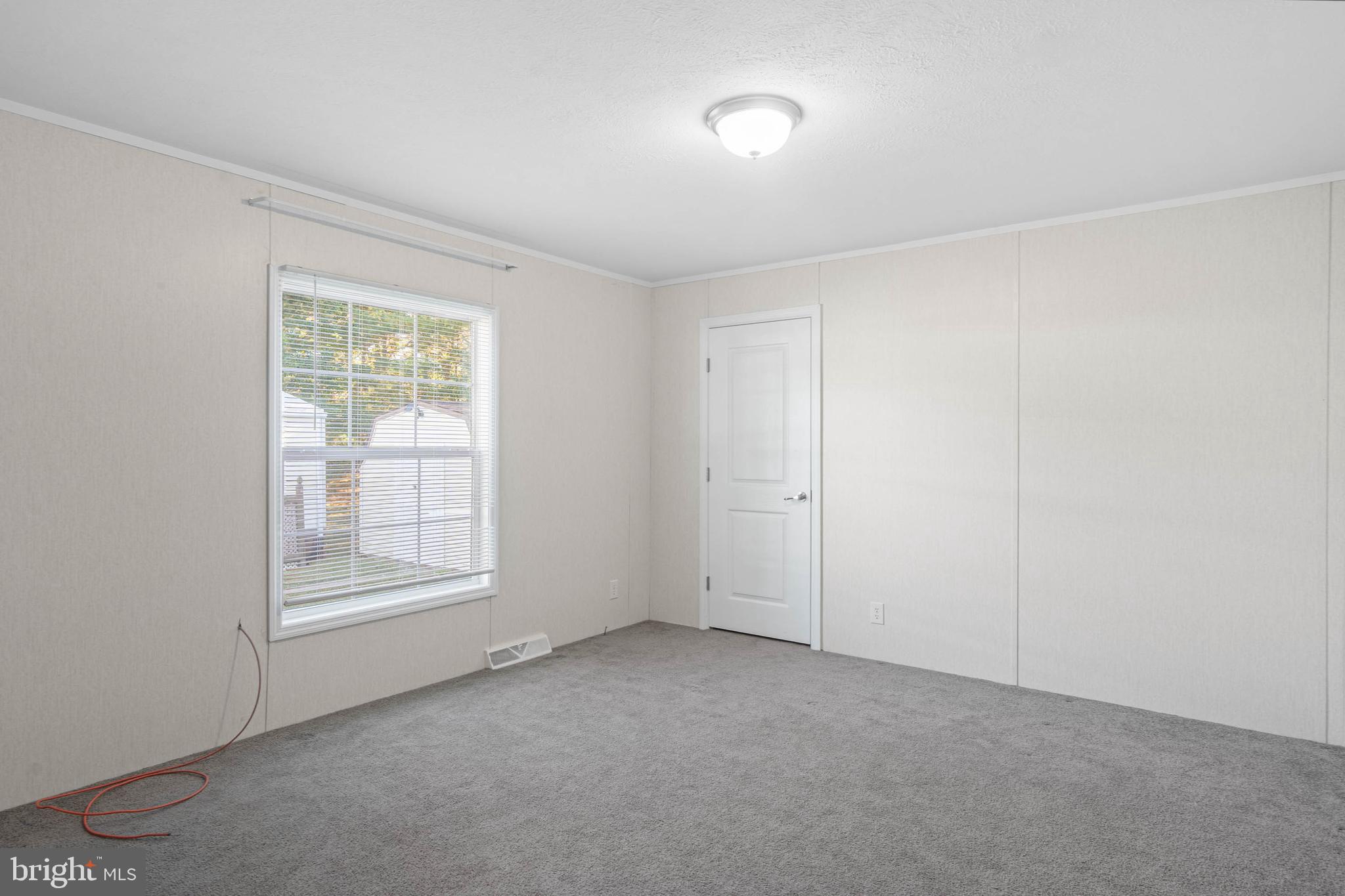 17247 Pine Water Drive Lewes, DE 19958 - Photo 16 of 32 an empty room with windows and closet