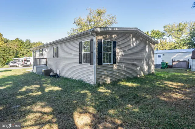 a aerial view of a house with a yard and sitting area